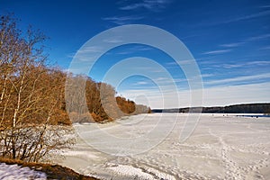 Early Spring With Melting Ice And Snow. Nature in March. Lake and forest rural scene