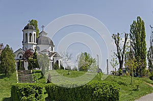 Early springtime green, bell tower and church with modern architecture in district Drujba