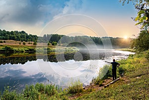 In the early summer morning, a fisherman is fishing in the upper reaches of the Volga River