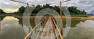 Early view of a bamboo bridge over the Khan river  in luang prabang