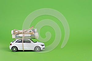 Earn cash with your car concept. Side profile full photo picture of small white car with rolls piles of usd money on top isolated