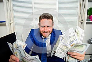 Earn money easy business tips. Man cheerful happy businessman with pile dollar banknotes. Profit and richness concept