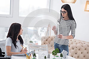 Earnest female colleagues fixing ideas