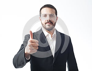 Earnest young businessman showing approval sign.