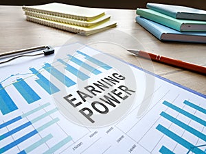 Earning power report with charts and pen.