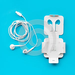 Earphone on blue pastel color.listen musical concepts