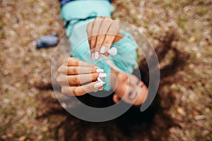 Earphones close up in girl's hands aerial top view