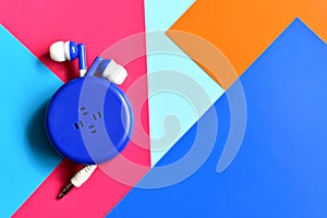 Earphones with extendable cord on colorful background