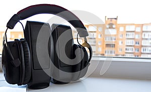 Earphones on musical loudspeakers close up. Headphones on stereo speakers