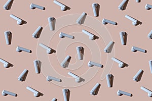 Earphones pattern isolated on pink background. Wireless headphones