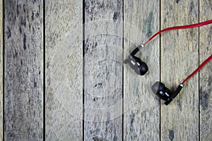 Earphones put on wood plank