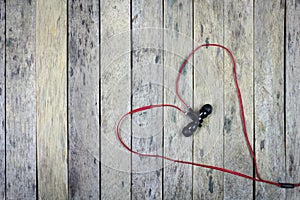 Earphones put on wood plank