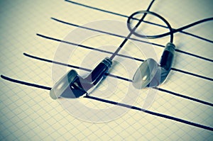 Earphones on a staff simulating musical notes