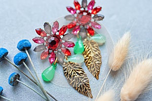Earrings in Boho style with large bright stones on a light background