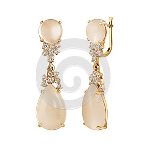 Earrings of gold with diamond and topaz on white background