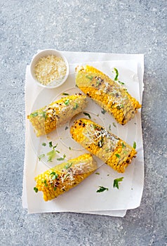 Ears of corn baked with herbs and parmesan cheese