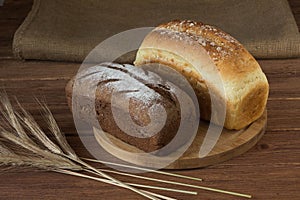 Ears of rye and corn bread on a wooden Board
