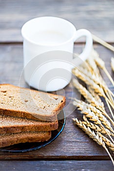 Ears of Wheat, Bread and Milk on Wooden Background