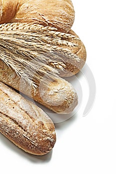 Ears of wheat and rie on loafs of bread isolated