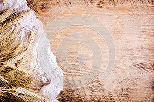 Ears of wheat on wooden background. Frame