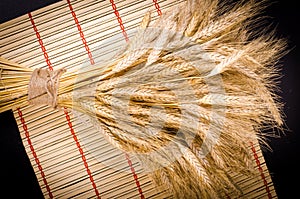Ears of wheat on wooden background. Frame