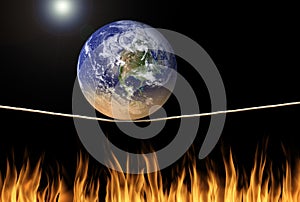 Earth balancing on tightrope over fire environmental climate change message