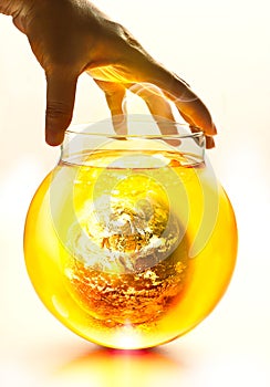 Earth burning in the bottle and yellow water boil under hand, Environment concept-Earth original image from NASA