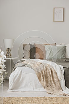 Earth colors in stylish bedroom interior with king size bedr