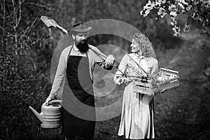 Earth concept. Image of two happy farmers with instruments. A farmer and his wife standing in their field. Farmers