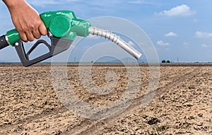 Earth Conservation. Gas pump nozzle and desert background. Fuel dispenser on desert nature background.