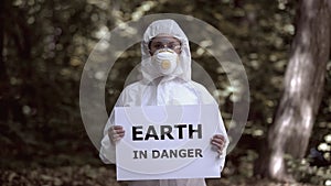 Earth in danger sign in female researcher hands, ecological problem, pollution