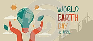 earth day concept with human hands holding light bulb shape