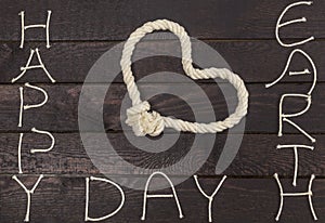 Earth Day concept. Rope in shape of love heart with text: Happy Earth Day