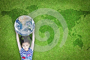 Earth day, ecological friendly and corporate social responsibility concept with kid raising world on green lawn