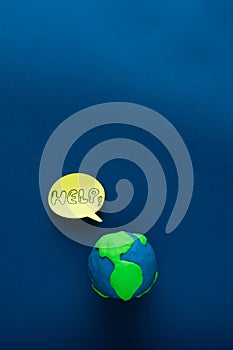 Earth Day. Globe on blue background with HELP message. Space copy