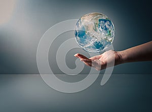 Earth day, Human hand holding blue earth on grey background , save earth conceptel ,ements of this image furnished by NASA , copy