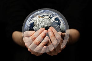 Earth day. Human hands holding blue earth planet, save earth concept. Elements of this image furnished by NASA