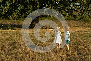 Earth day. Little family farmers. Eco farm for kids. Children farmer in the farm with countryside background. Springtime