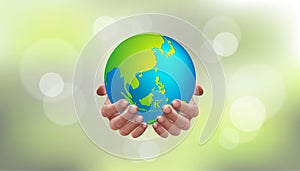 Earth day save our planet concept. Human hands holding globe with bokeh blur background. World environment day. go green.