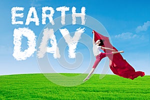 Earth Day text with woman holds fabric