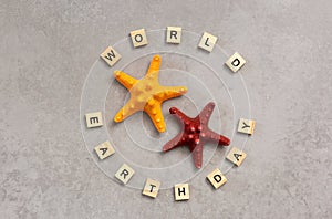 Earth day word with starfish on grey background, earth day concept