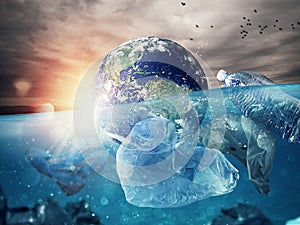 The Earth floats in the sea full of plastic. Save the World. World provided by NASA.