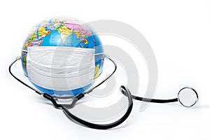 Earth globe with antiviral surgical protective face mask and stethoscope on white background. Protect planet concept.