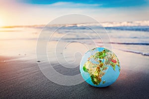 Earth globe on the beach