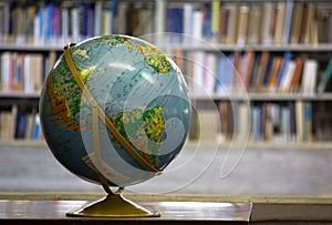 Earth Globe on a gold basis with a library background