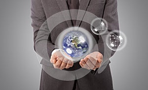 Earth globe in hand, Elements of this image furnished by NASA