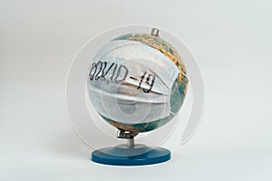 Earth globe with medical mask on white background, global pandemic covid-19, coronavirus