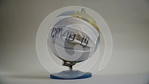 Earth globe with medical mask on white background, global pandemic covid-19, coronavirus