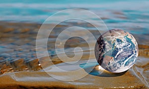 Earth globe on seashore background