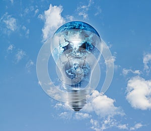 Earth globe and storm in the light bulb on a blue sky vibrant